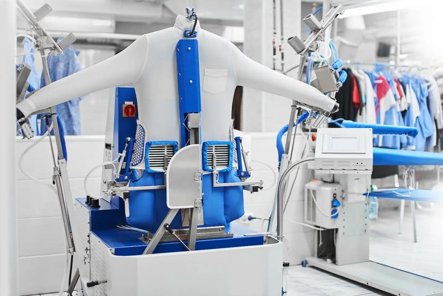 Shirt laundry pressing line at Joe’s Organic Dry Cleaners with dress shirts being professionally pressed