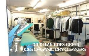 Work area at Joe’s Organic Dry Cleaners showing modern dry cleaning and pressing equipment